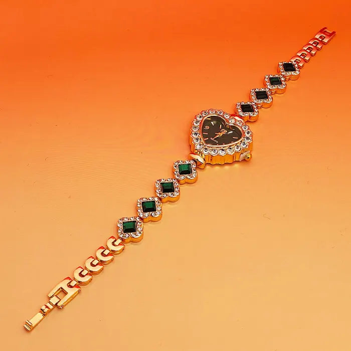 Heart stone watch with black dial and alternating green gemstone bracelet links offering a sparkling elegant gold accessory design for women