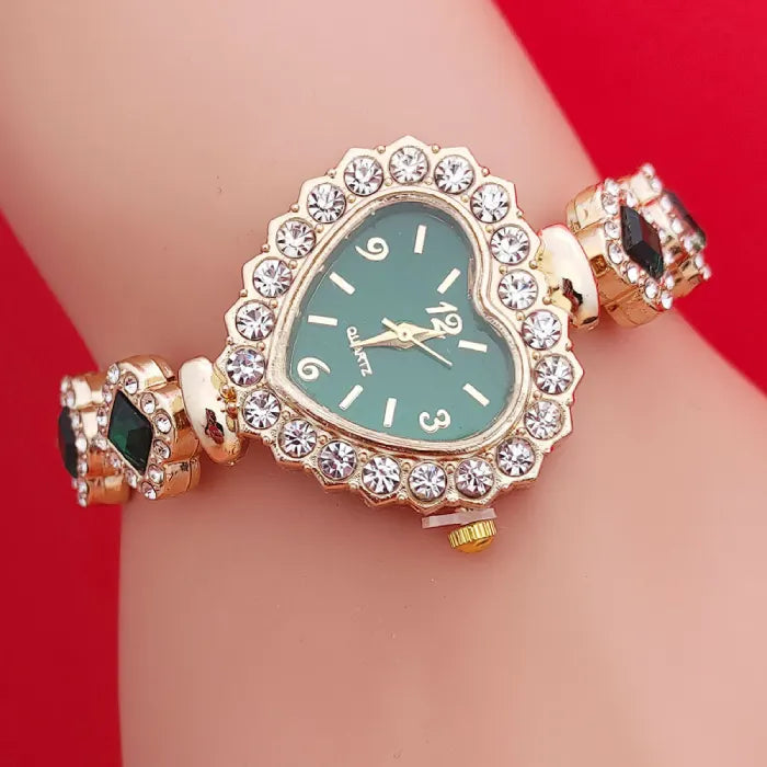 Heart stone watch with green dial and crystal-studded heart frame worn on wrist showing matching green gemstone bracelet accents for stylish wear