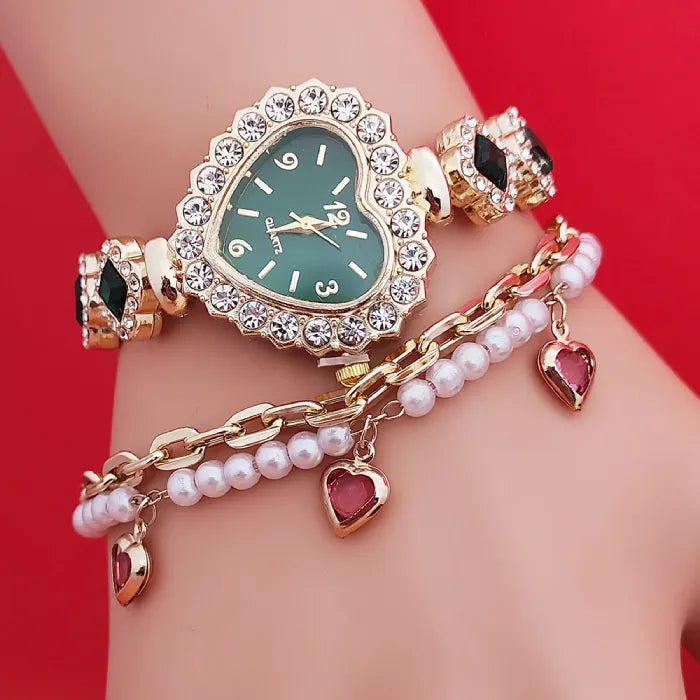 Heart stone watch with green dial and crystal heart frame styled on wrist with pearl charm bracelet for elegant fashionable accessorizing