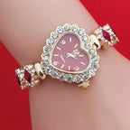 Heart stone watch with red dial and crystal heart frame worn on wrist featuring red gemstone bracelet accents for glamorous feminine style