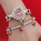 Heart stone watch with red dial and jeweled frame worn with pearl charm bracelet offering luxurious sparkling accessory style for women