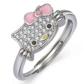 Close-up of hello kitty jewelry set ring with pink bow and sparkling crystals on silver band.