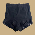 high waisted butt lifting shapewear laid flat in black, highlighting lace trim, shaping waistband, and sculpting compression zones