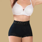 high waisted butt lifting shapewear in black worn by model, featuring lace trim and firm compression for smooth shaping and curve boost