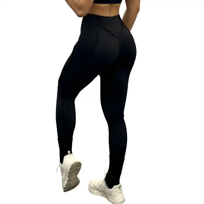 High-waisted leggings in black shown from the back, contouring seams with a snug gym-fit style.