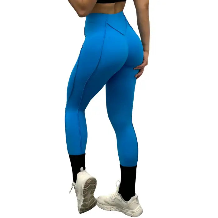 High-waisted leggings in blue from the back, highlighting curve-enhancing seams and snug fit.