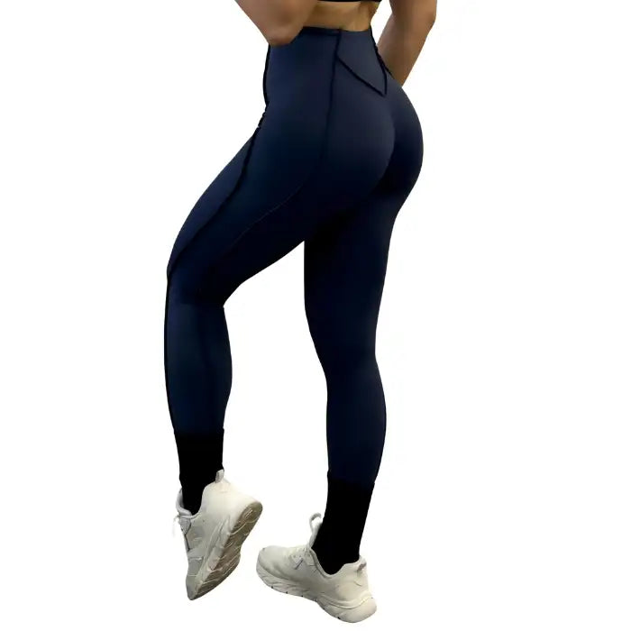 High-waisted navy leggings in rear view showing seam placement and snug, curve-hugging shape.