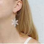 Holiday earrings white snowflake dangle shown on ear, 35 mm