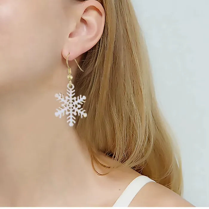 Holiday earrings white snowflake dangle shown on ear, 35 mm