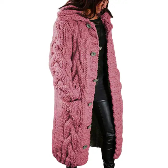 Hooded cable knit cardigan coat long chunky in dusty pink with intricate cable pattern, front pockets.