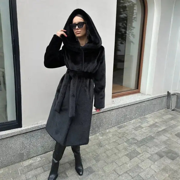 Hooded long plush coat in dark brown with belt and sunglasses for chic cold-weather street style.