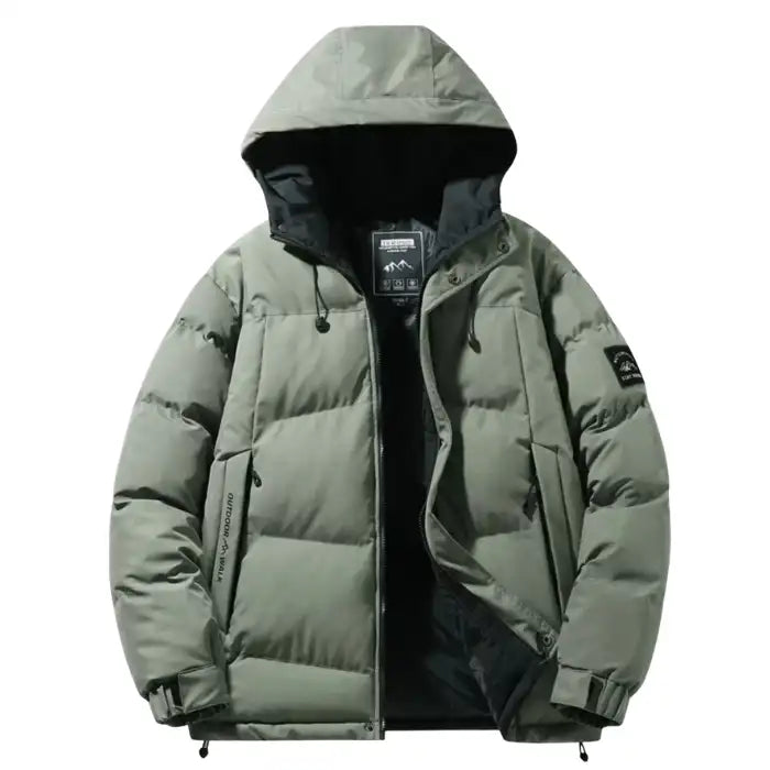  Hooded quilted puffer jacket with black interior in sage green, front view partially unzipped with adjustable cuffs.