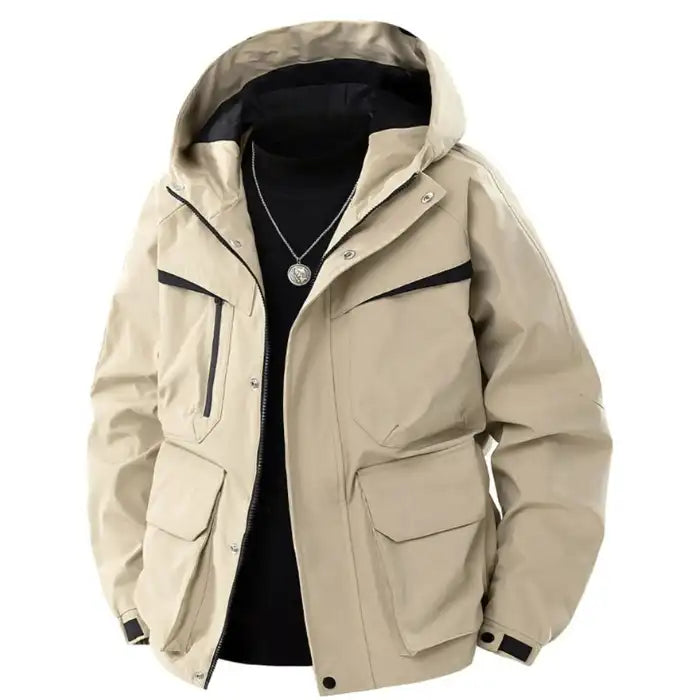  Hooded utility bomber jacket with cargo pockets in tan beige, showing layered zip design and flap pockets, front view.