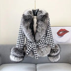 Houndstooth coat with faux fur trim, black and white pattern, gray fur collar and cuffs, belted waist, front view.