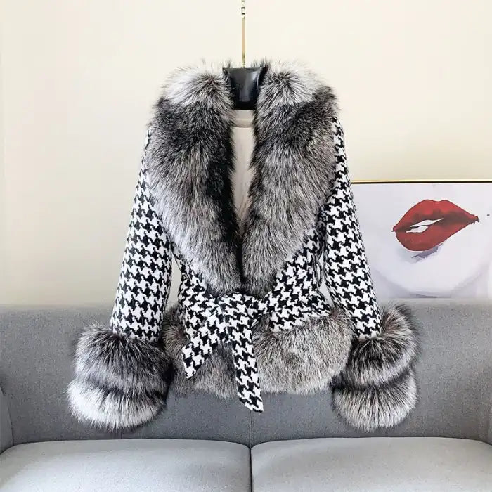 Houndstooth coat with faux fur trim, black and white pattern, gray fur collar and cuffs, belted waist, front view.