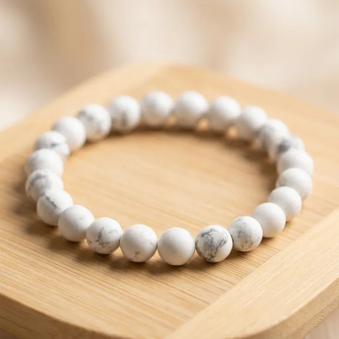 howlite stone matte bead bracelet on wooden surface showcasing minimalist jewelry style and calming balance for everyday wear