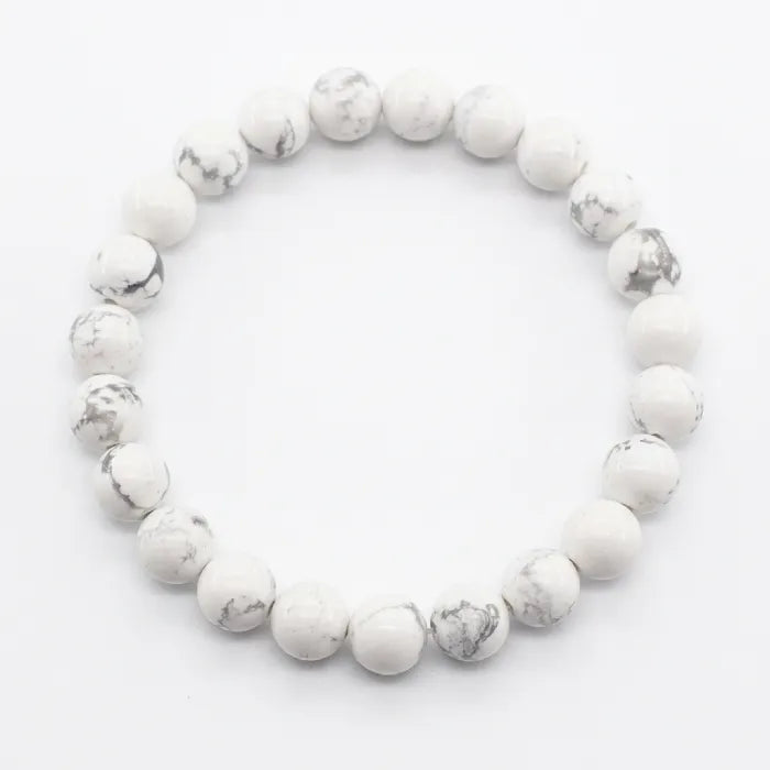 howlite stone round bead bracelet on white surface showcasing polished natural texture and peaceful energy for stress relief