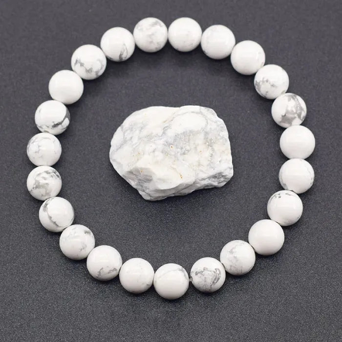 howlite stone round bead bracelet arranged with raw mineral centerpiece highlighting natural texture and soothing energy benefits