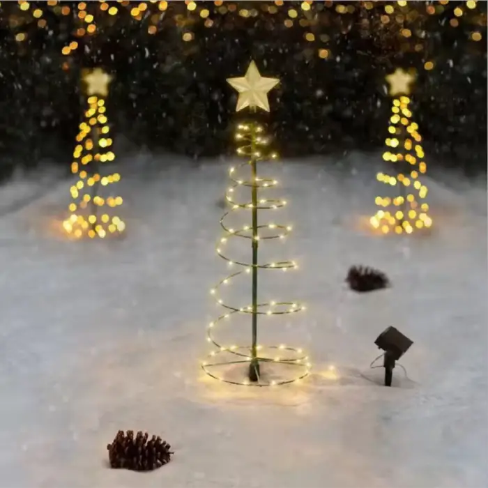 Glowing spiral Christmas trees with warm LED lights illuminating a snowy scene, creating a magical winter atmosphere