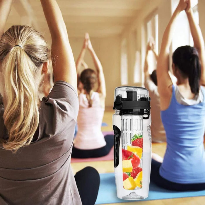 Clear infuser water bottle used in a yoga class setting, perfect for fitness enthusiasts.