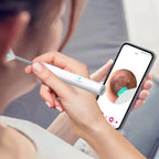 Person using a smart ear cleaner tool with smartphone app for safe ear cleaning.