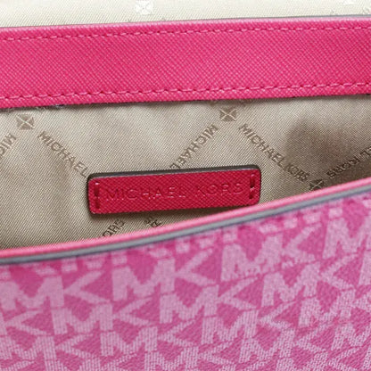 Inside view of Michael Kors pink bag, showcasing branded lining and spacious interior for essentials.