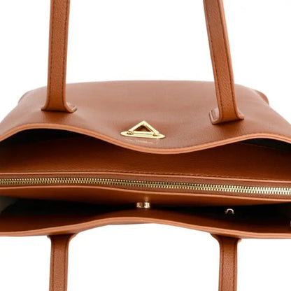 Inside view of brown leather tote bag, showing zipper closure, compartments, and gold-toned hardware