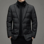 Insulated jacket with blazer design in black shown from the front with hands in pockets.