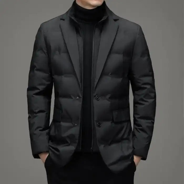 Insulated jacket with blazer design in black shown from the front with hands in pockets.
