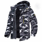 Insulated winter jacket hooded in grey camouflage pattern with warm inner lining.