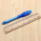 invisible ink pen with uv light in blue shown next to ruler for size reference