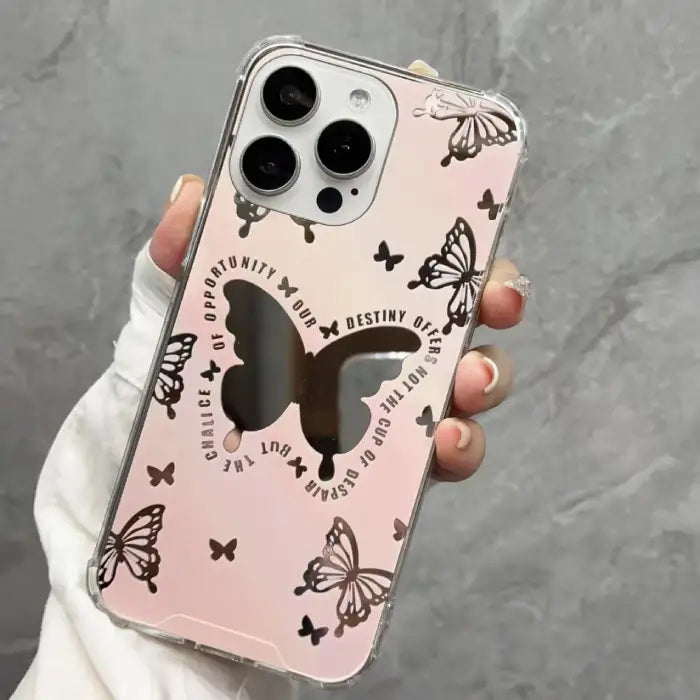iPhone 15 case with black background featuring white butterfly patterns and central purple butterfly accent with motivational text