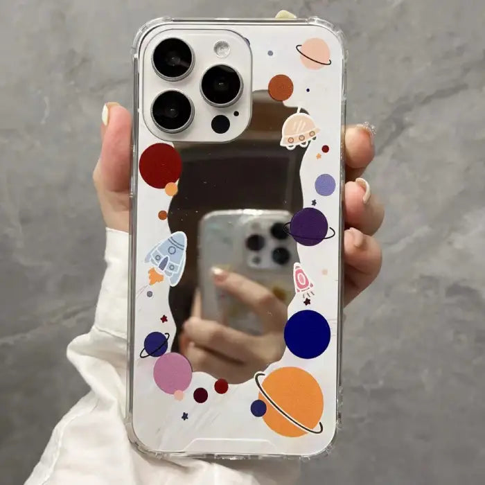 iPhone 15 case with minimalist white background featuring black circular elements and "outer space" text for a clean aesthetic look