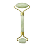 Jade facial roller with gold accents on a white background