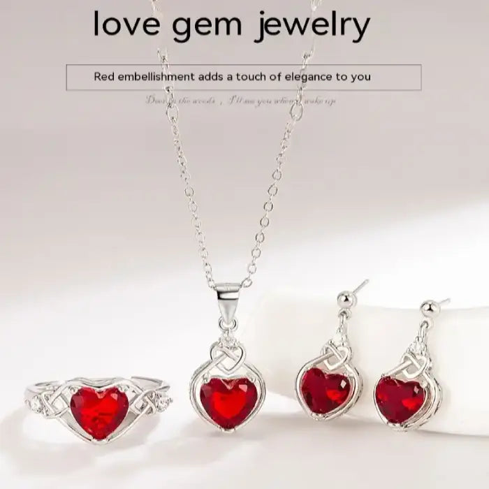 Complete jewelry set with necklace, earrings, and ring featuring heart-shaped red gemstones.