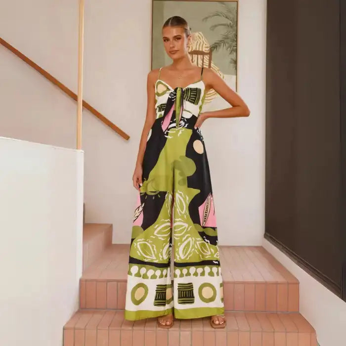  Jumpsuit with abstract green, pink, and black print featuring tie-front top and wide-leg silhouette.