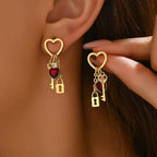 key and locket earrings shown on ears with gold heart tops red gem hearts and hanging key lock charms