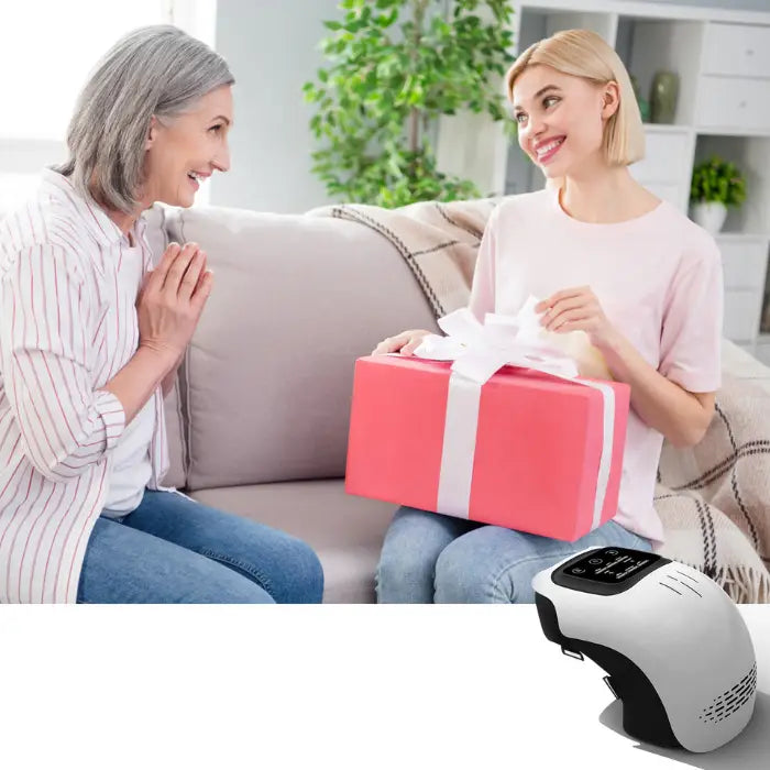 Young woman giving pink gift box to older woman, with knee massager shown as ideal gift