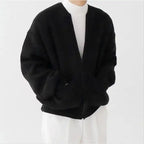Knit Cardigan in black styled with white turtleneck and pants for a clean, minimal menswear outfit.