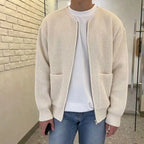 Knit Cardigan in cream with ribbed texture, zip front, and dual pockets worn over white tee and jeans.