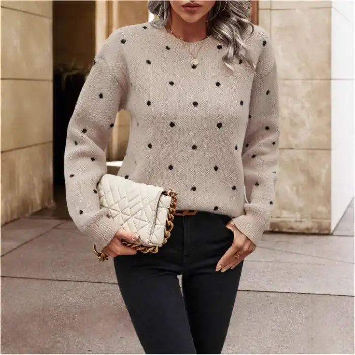 Knit crew neck polka dot pullover sweater in beige, closeup front view showing textured knit and black dots.
