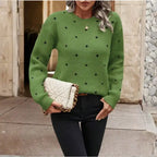  Knit crew neck polka dot pullover sweater in green with black dots, cozy textured knit, front view.