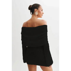 Knitted black dress back view showing off-shoulder fit and textured sleeve details.