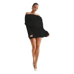 Knitted mini dress in black with long sleeves, off-shoulder neckline, and white heels.