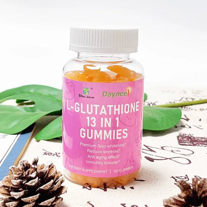 Daynee L-glutathione gummies bottle with decorative pinecones and tropical leaves