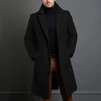 Black lapel trench coat paired with brown pants and black turtleneck for a sleek formal outfit.