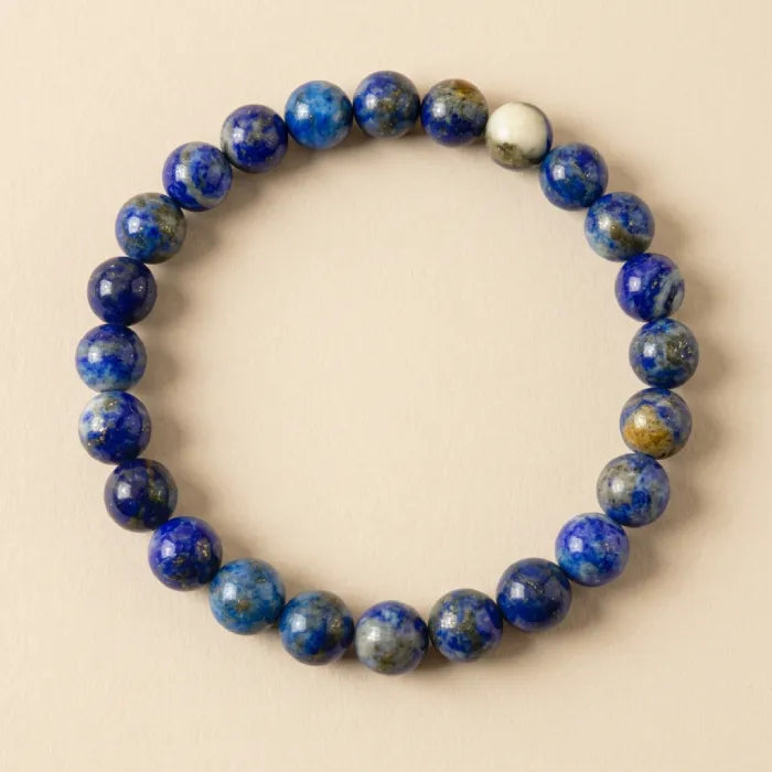 Lapis lazuli bracelet in a clean top view, polished blue crystal bead jewelry for minimalist daily wear appeal