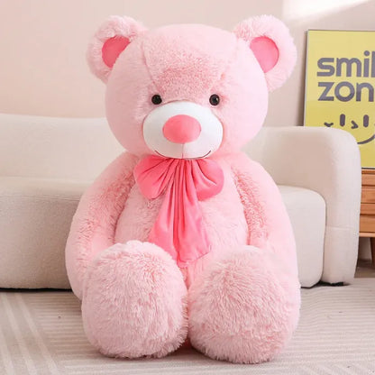 Brown teddy bear with a beige bow sitting on a modern white armchair.