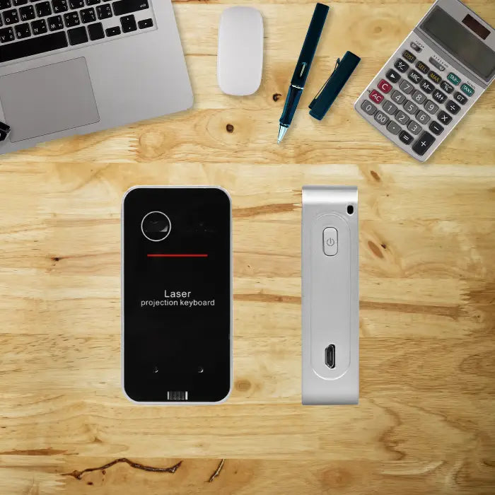 Laser projection keyboard device shown with USB port on wood desk background.