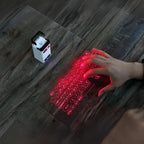 Laser projection keyboard showing red virtual keyboard with hand typing on wood surface.
